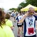 A Dexter-Ann Arbor runner puts a medal around his neck after crossing the finish line on Sunday, June 2. Daniel Brenner I AnnArbor.com